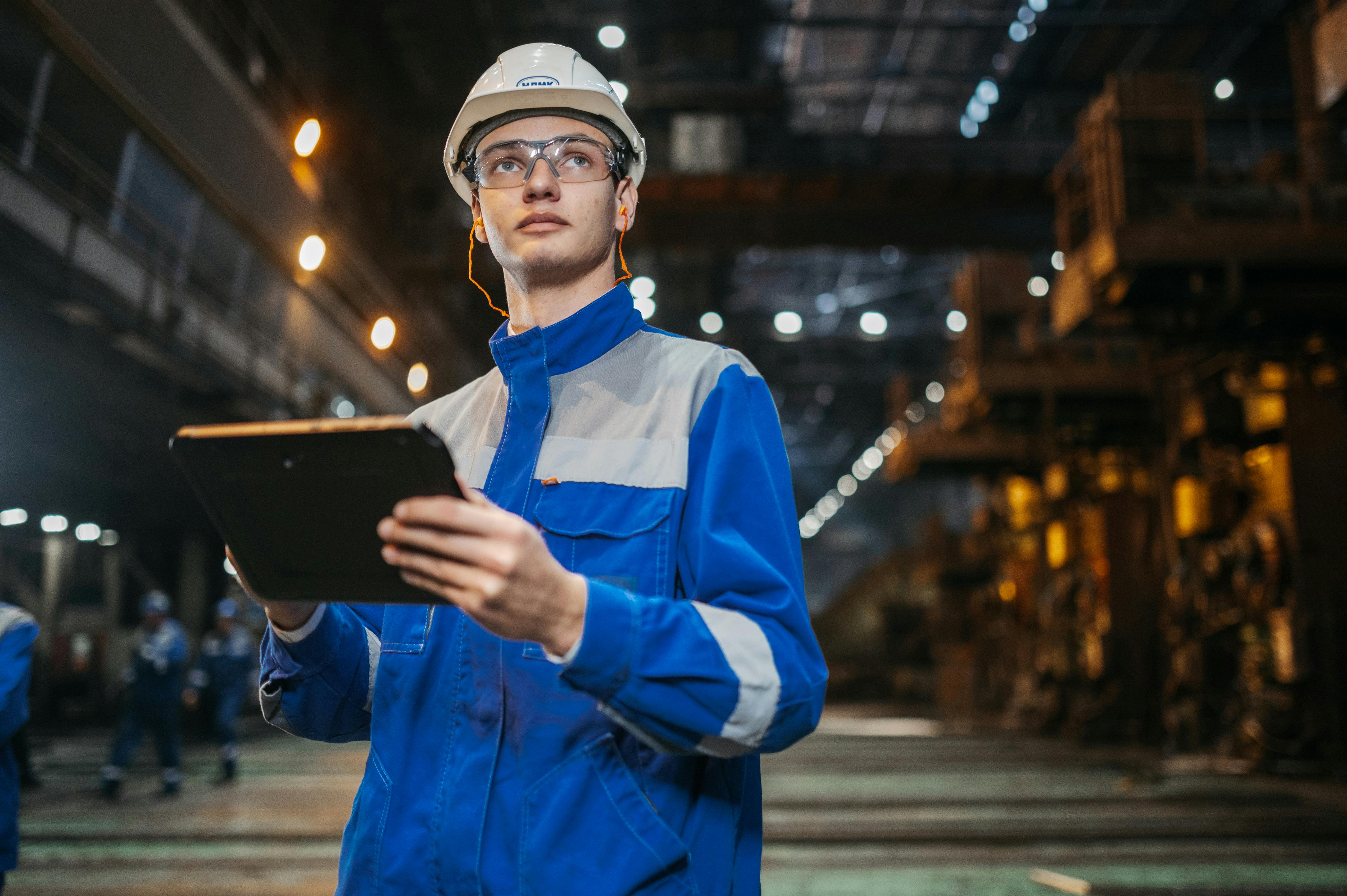Engineer in industrial factory using tablet