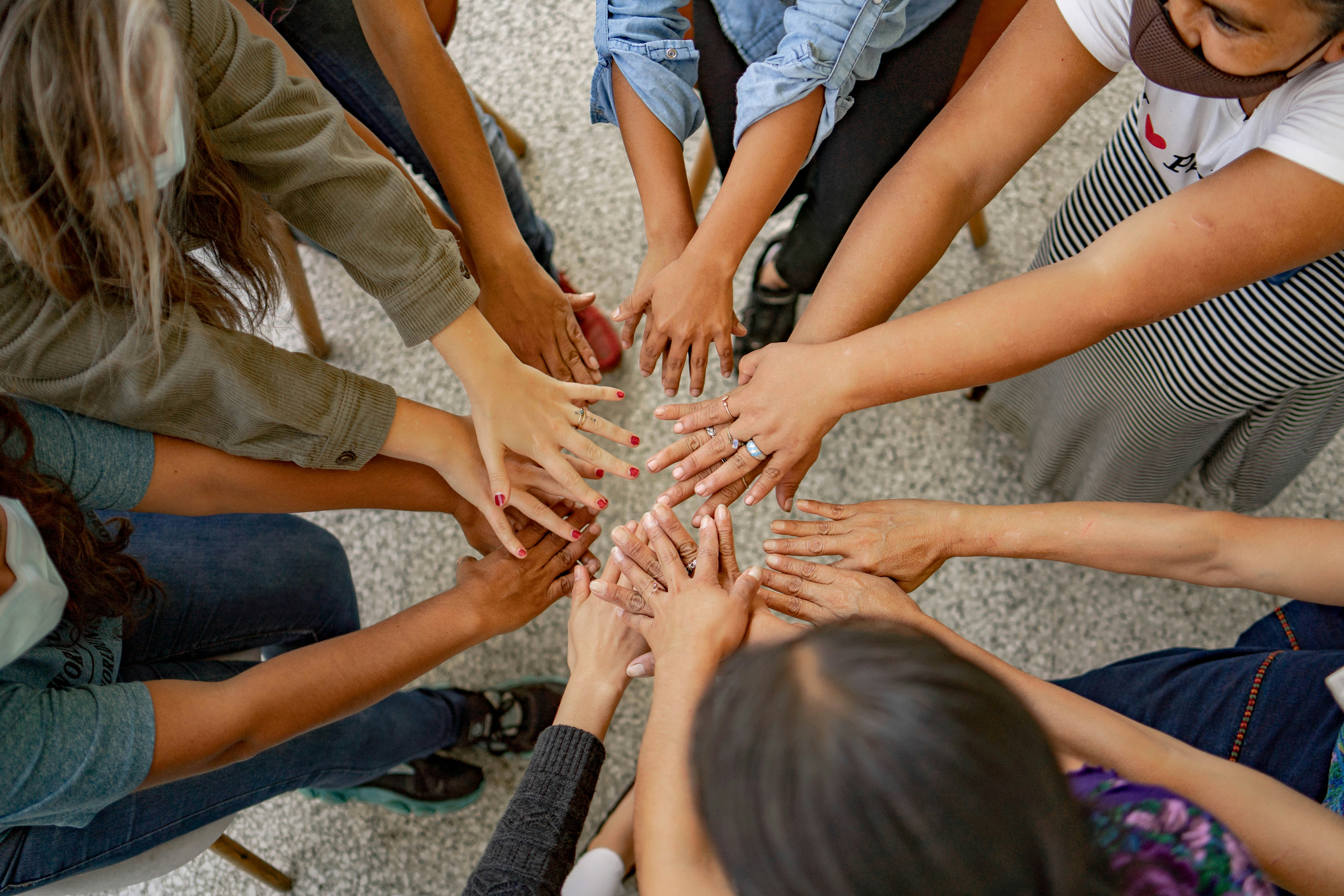 Group of people joining hands in a circle